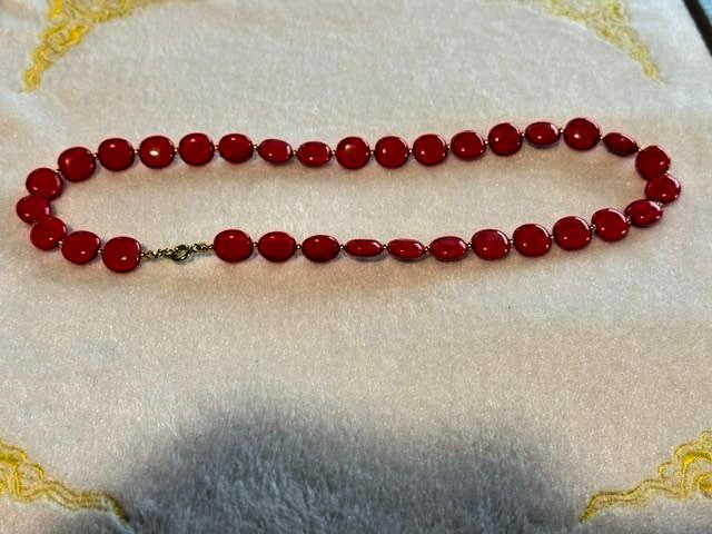 Red flat round beaded necklace with disc-shaped glossy beads and small gold-tone