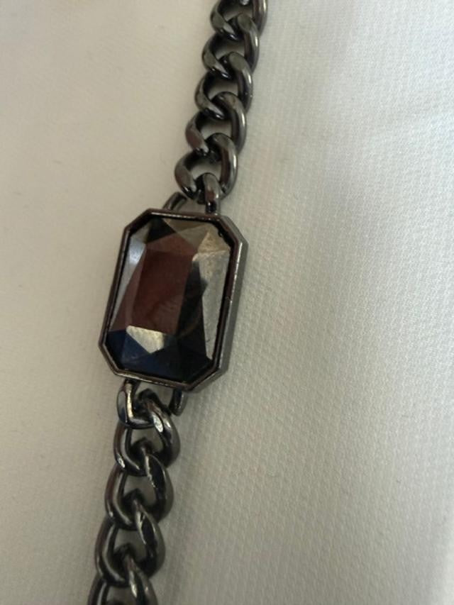 Gunmetal-tone curb-chain bracelet featuring a large rectangular faceted smoky