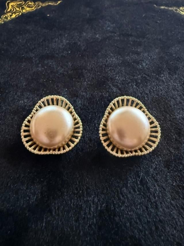 Vintage faux pearl earrings featuring soft champagne-colored pearl cabochons set