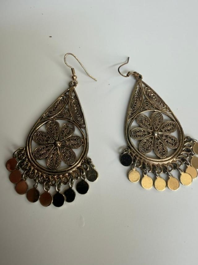 filigree Indian-style dangle earrings featuring an open teardrop frame, detailed