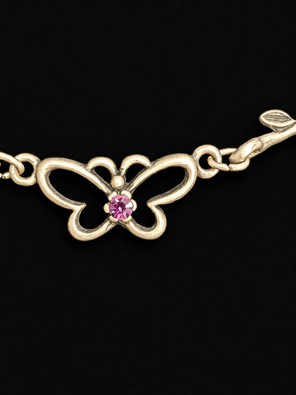 Openwork butterfly centerpiece with a pink rhinestone center