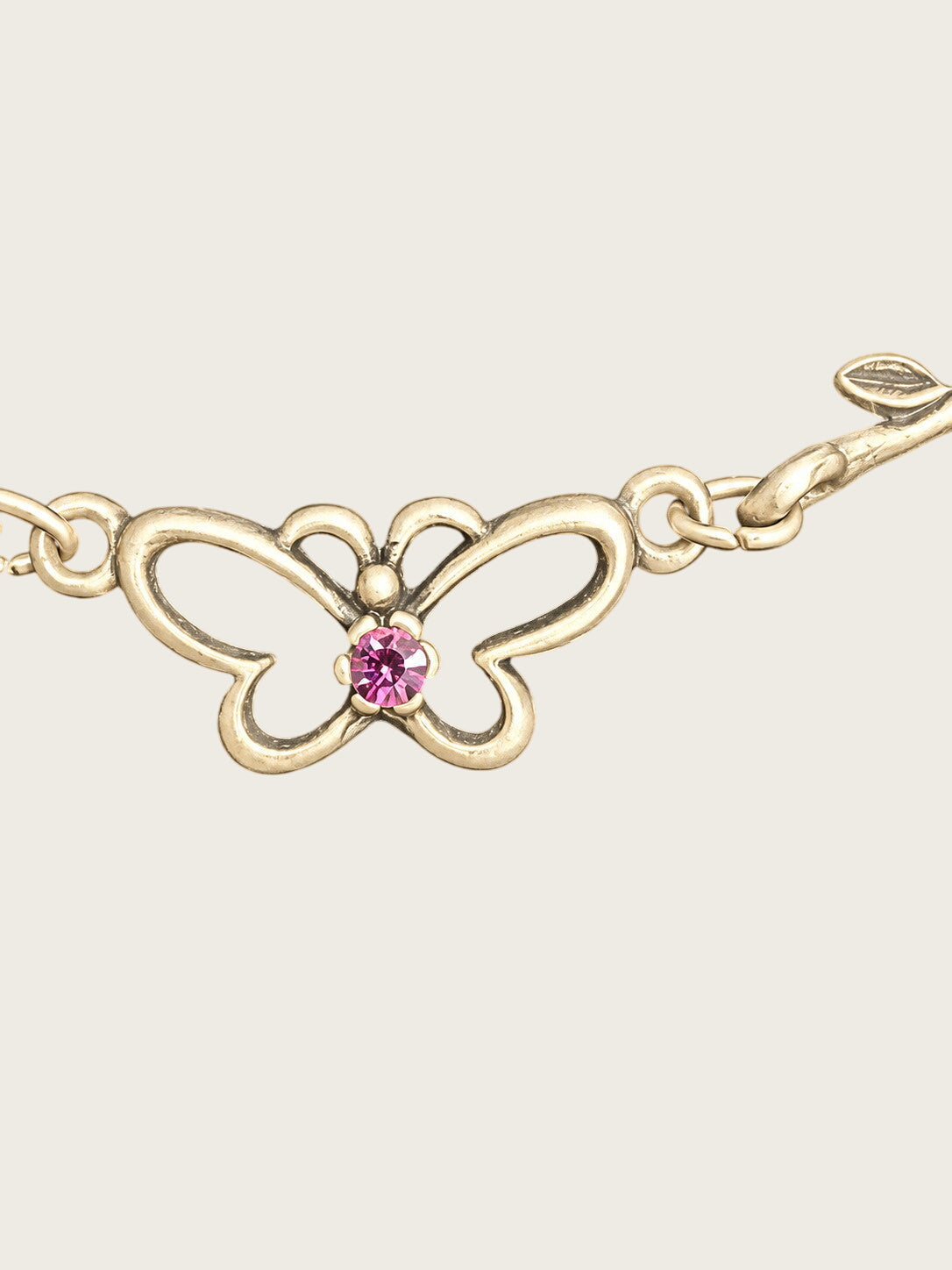 Openwork butterfly centerpiece with a pink rhinestone center