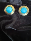 Vintage-style clip-on featuring a faux turquoise cabochon stone.