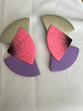 Memphis-style geometric clip-on earrings featuring layered fan-shaped pieces in