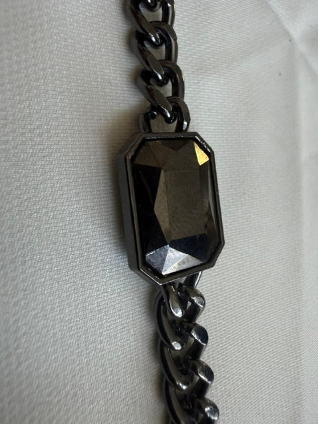 Gunmetal-tone curb-chain bracelet featuring a large rectangular faceted smoky