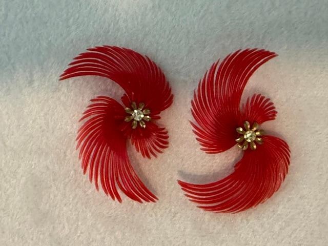 vintage soft-plastic feather or pinwheel clip-on earrings with clear rhinestone