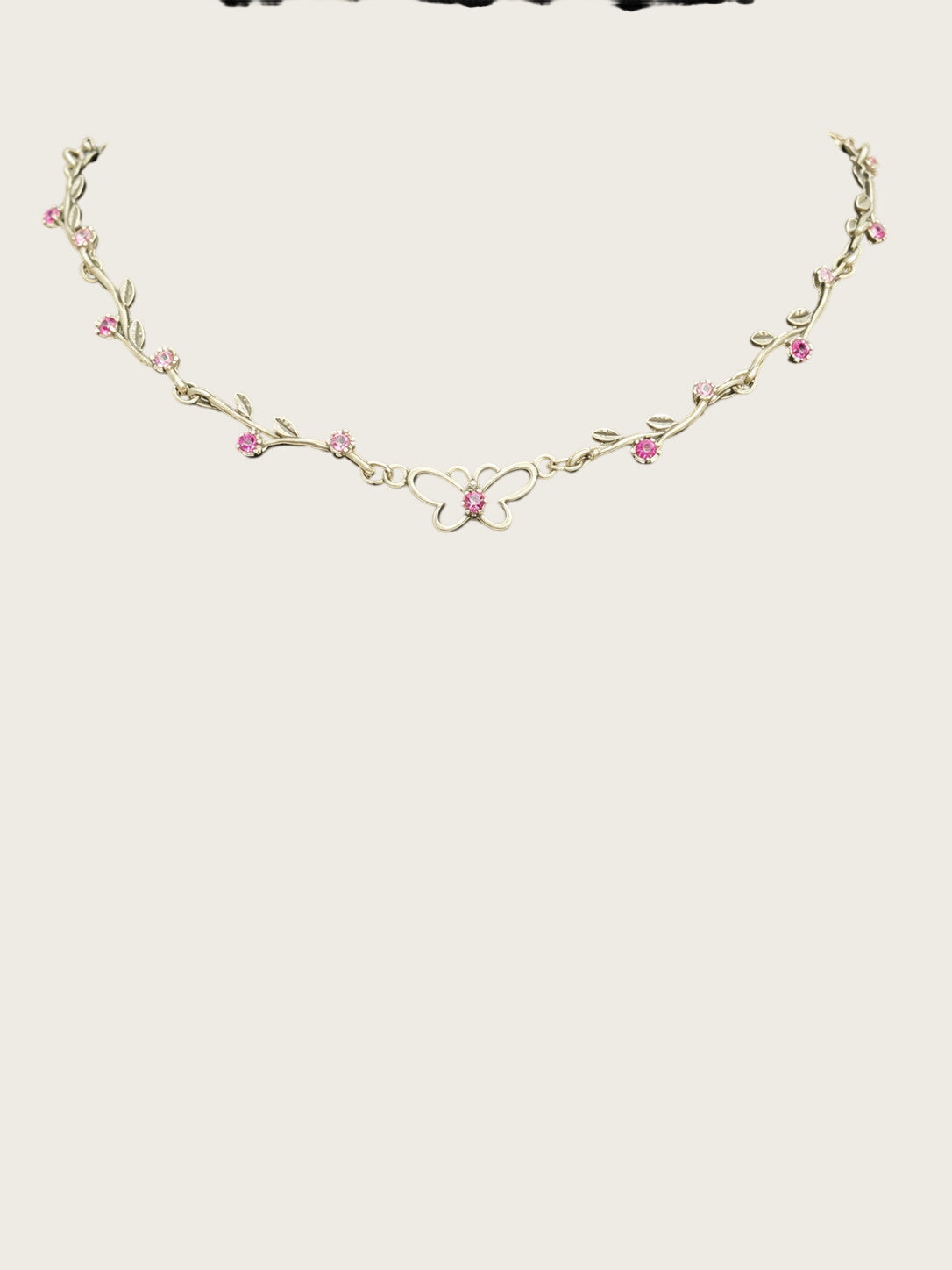 Openwork butterfly centerpiece with a pink rhinestone center