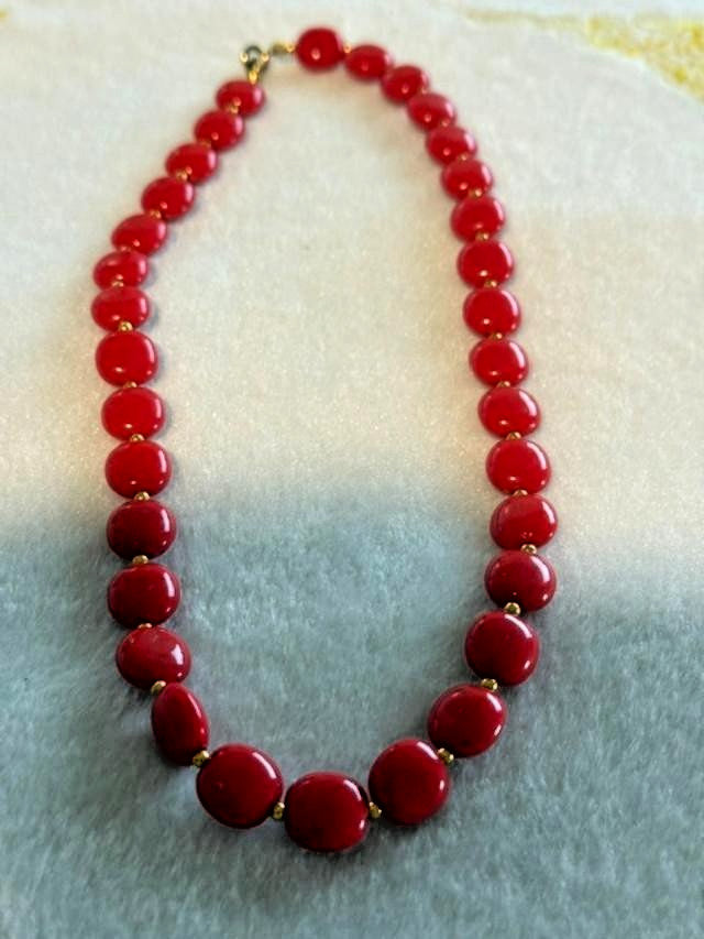 Red flat round beaded necklace with disc-shaped glossy beads and small gold-tone