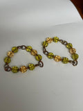 Pair of stretch-style beaded bracelets featuring faceted olive