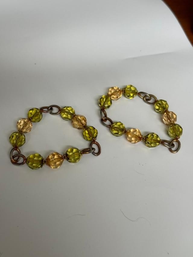 Pair of stretch-style beaded bracelets featuring faceted olive