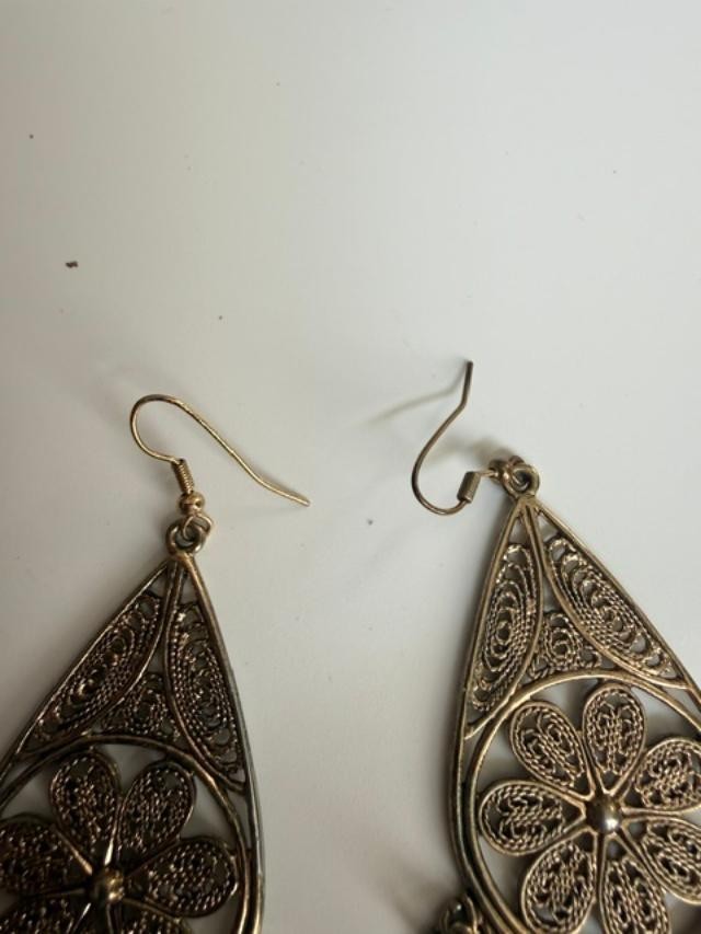 filigree Indian-style dangle earrings featuring an open teardrop frame, detailed